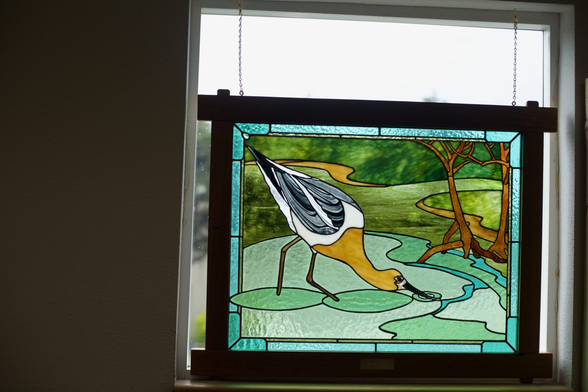 Stained glass image of a sea bird in water